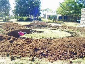 Water tank foundation being dug by hand